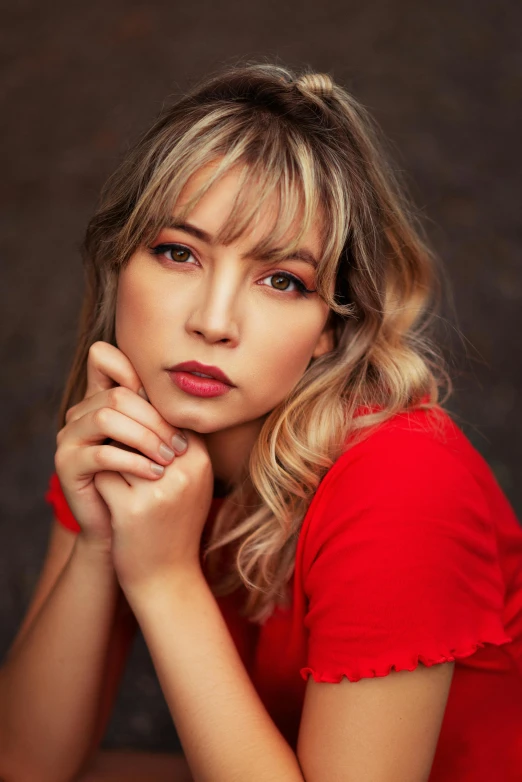 woman wearing a red shirt posing for a heads