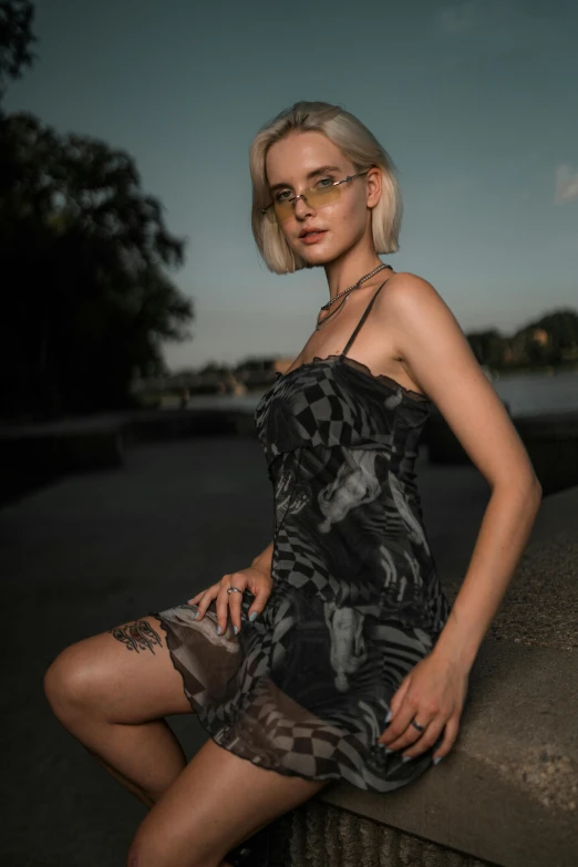 a woman sitting on a concrete wall with her leg in the air