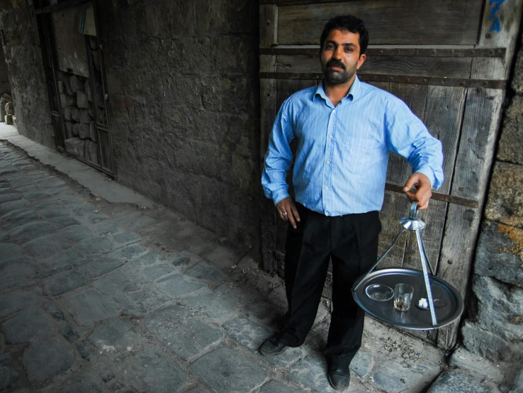 a man is standing in front of a building with an umbrella