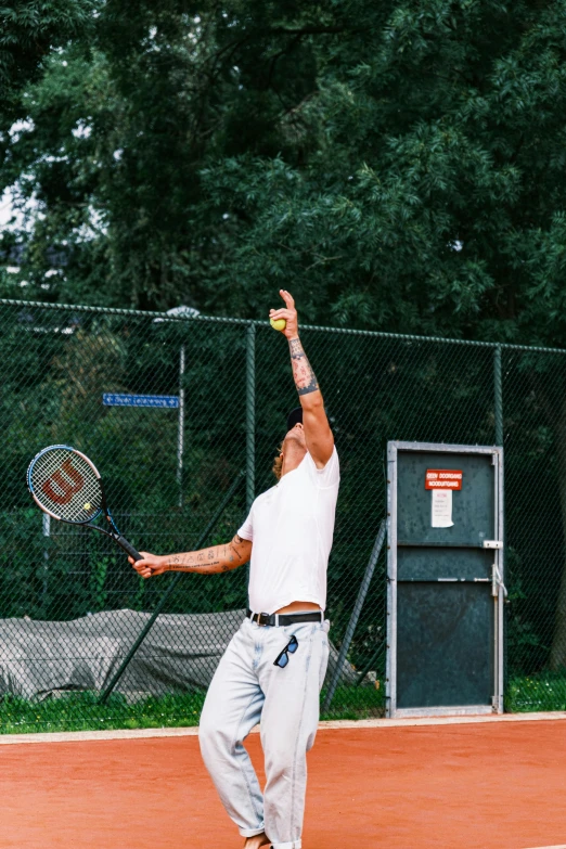 a tennis player reaching up to hit the ball