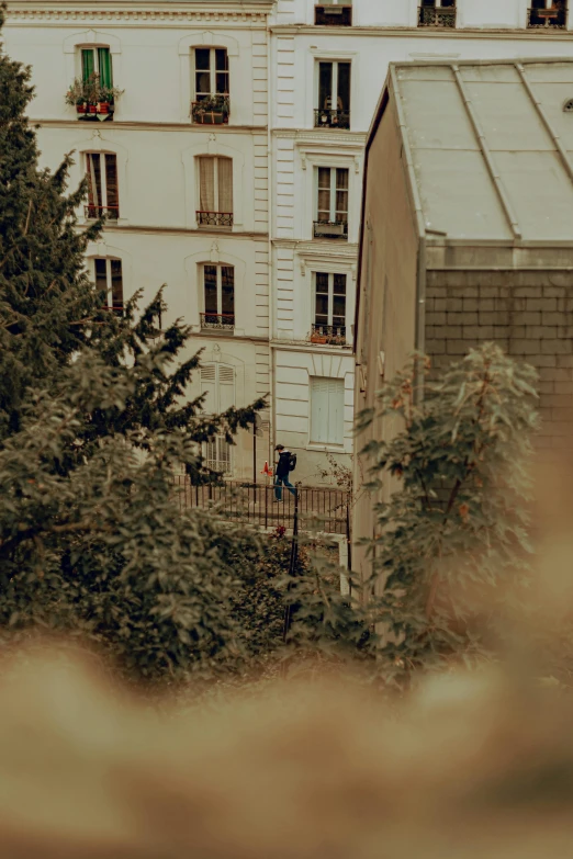 an open balcony and trees in front of a tall building