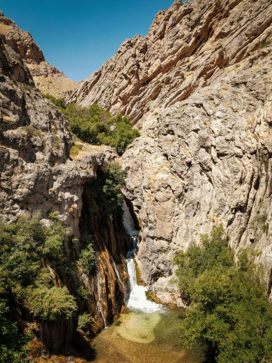 a small waterfall flowing into the mountain lake