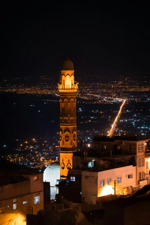 there is a tall tower with a clock that is at night