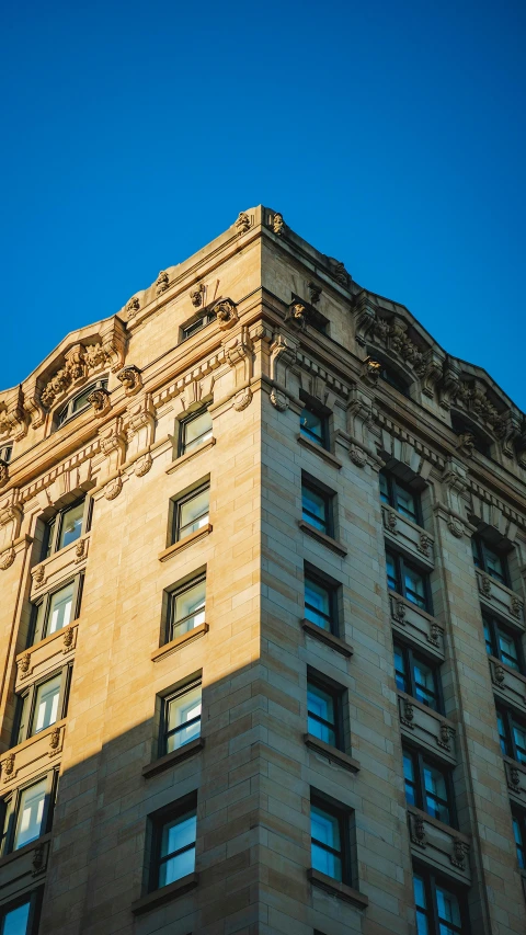 a tall building is shown with a sky background