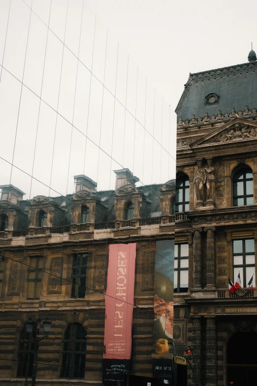 a large building has two flags in front of it