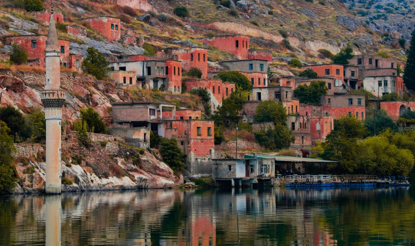 buildings and a water way on a hill