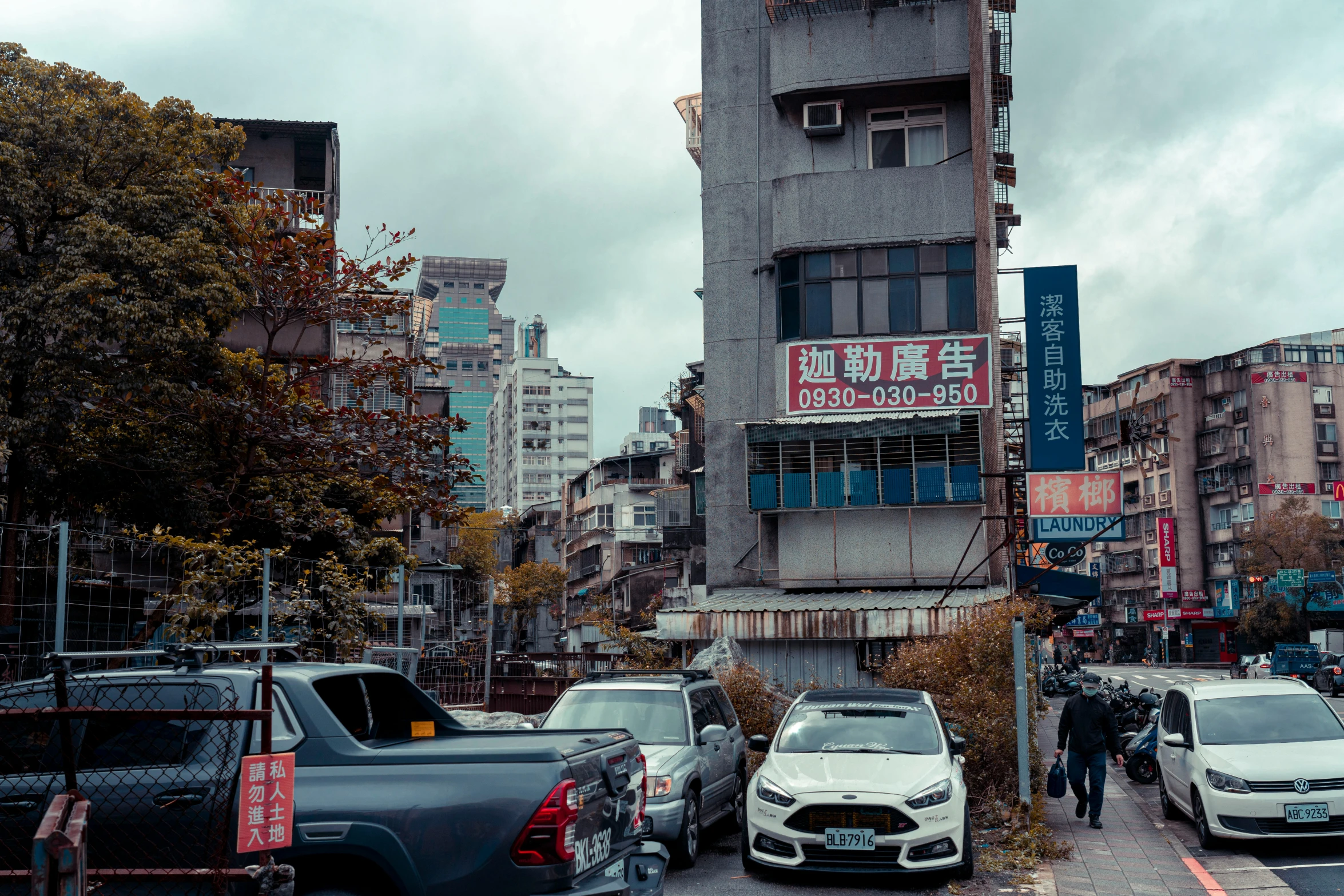 cars parked at curbs in a busy urban city