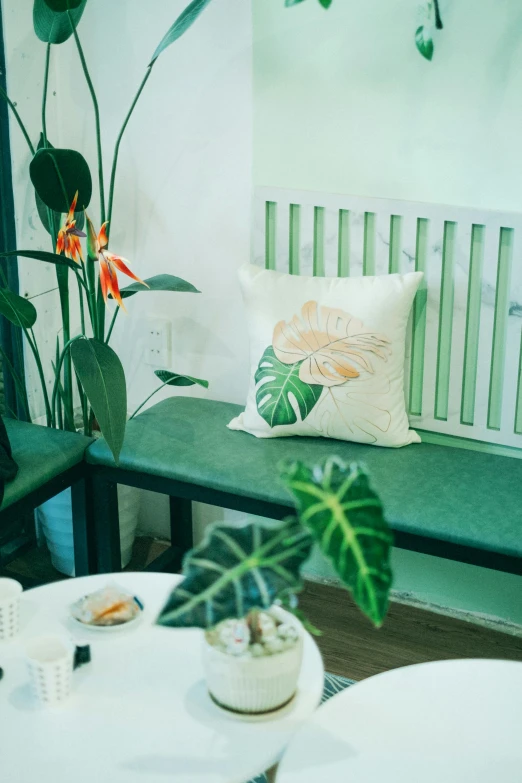 a small table with a bench next to it and some plants