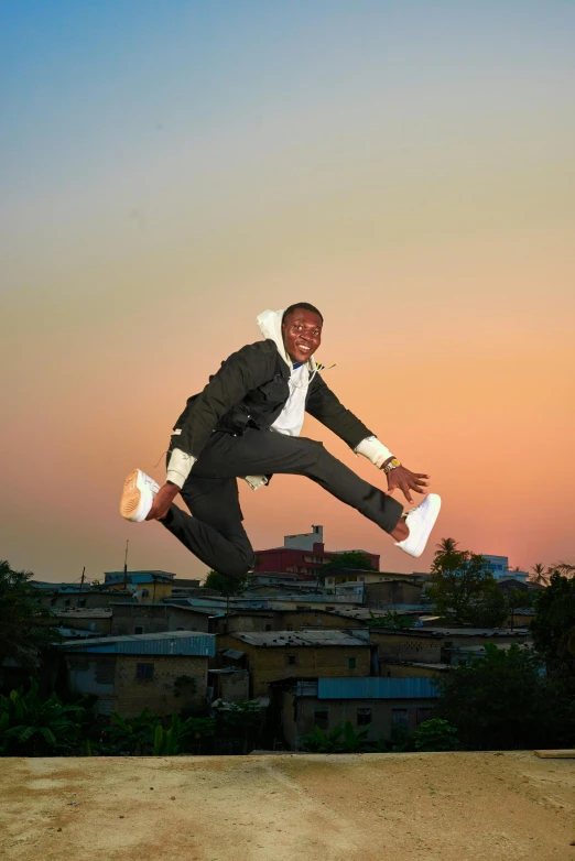 a young man flying through the air while wearing a suit