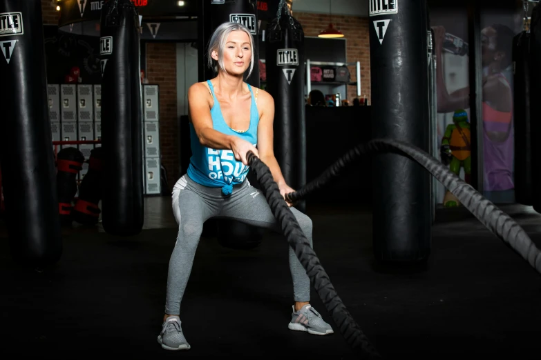 a woman with an olympic flag holding a rope