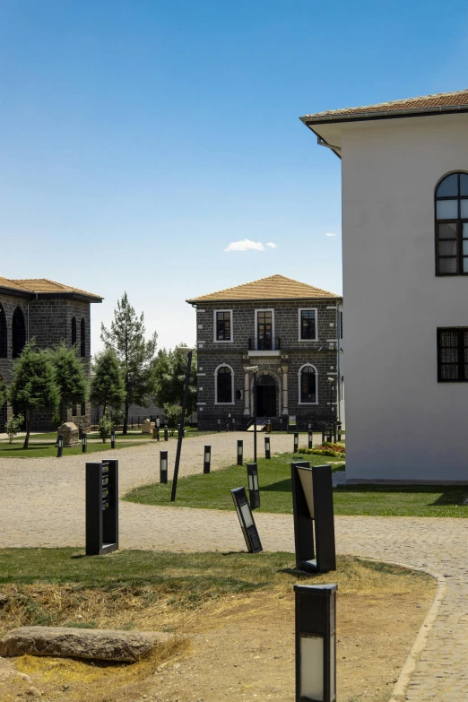 an old fashioned building is surrounded by statues and trees