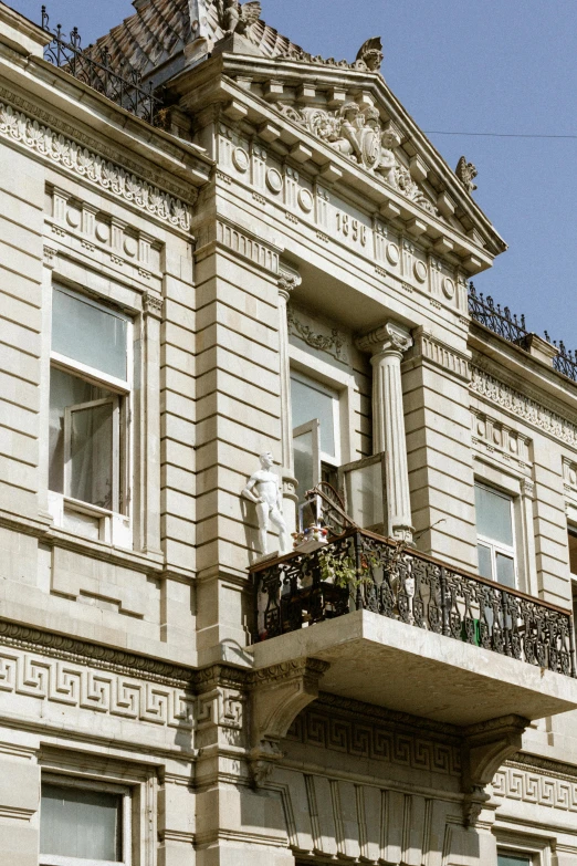 a tall building with ornate balconies has windows