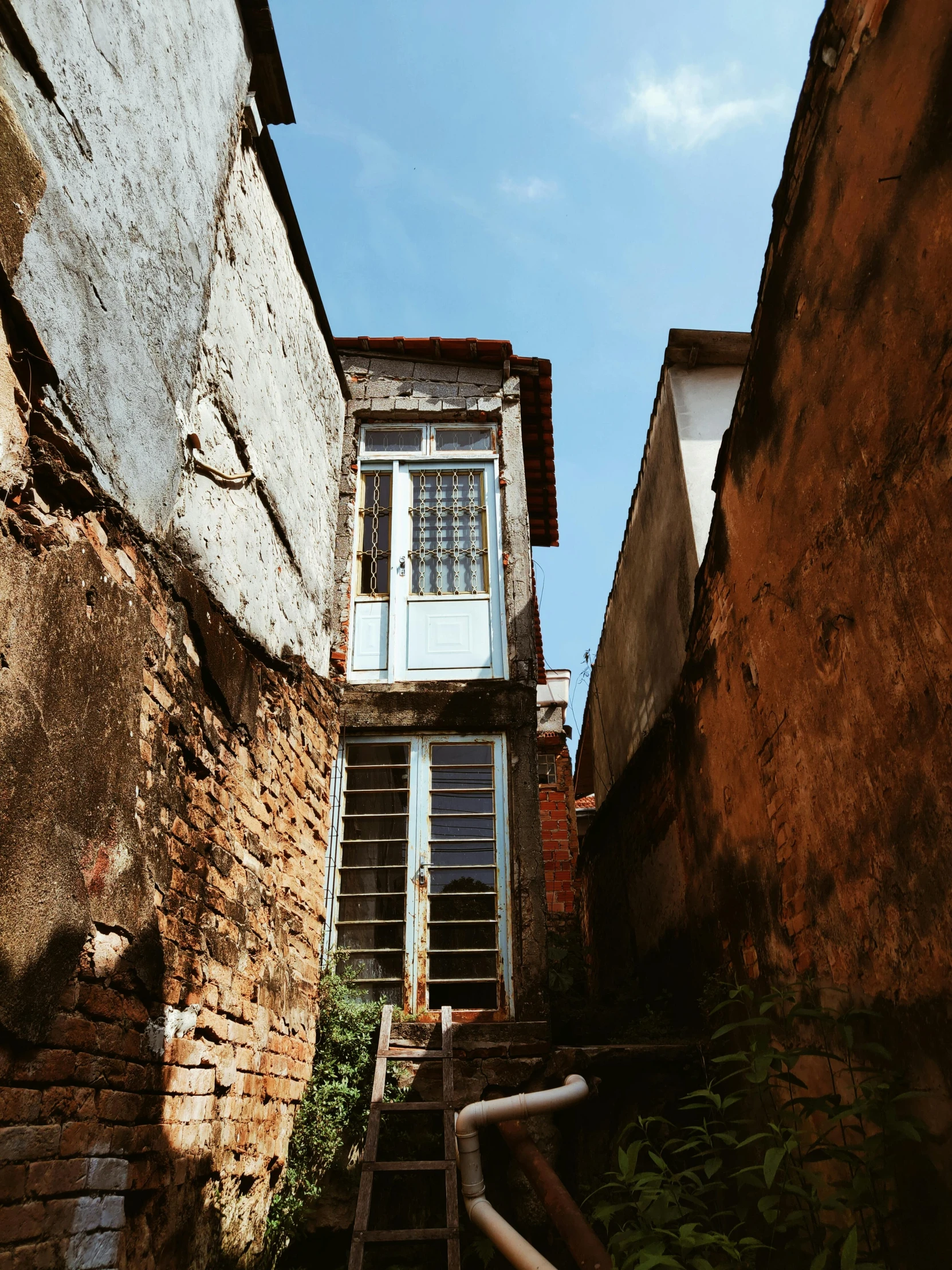 there is an old stair case that has a window on the top