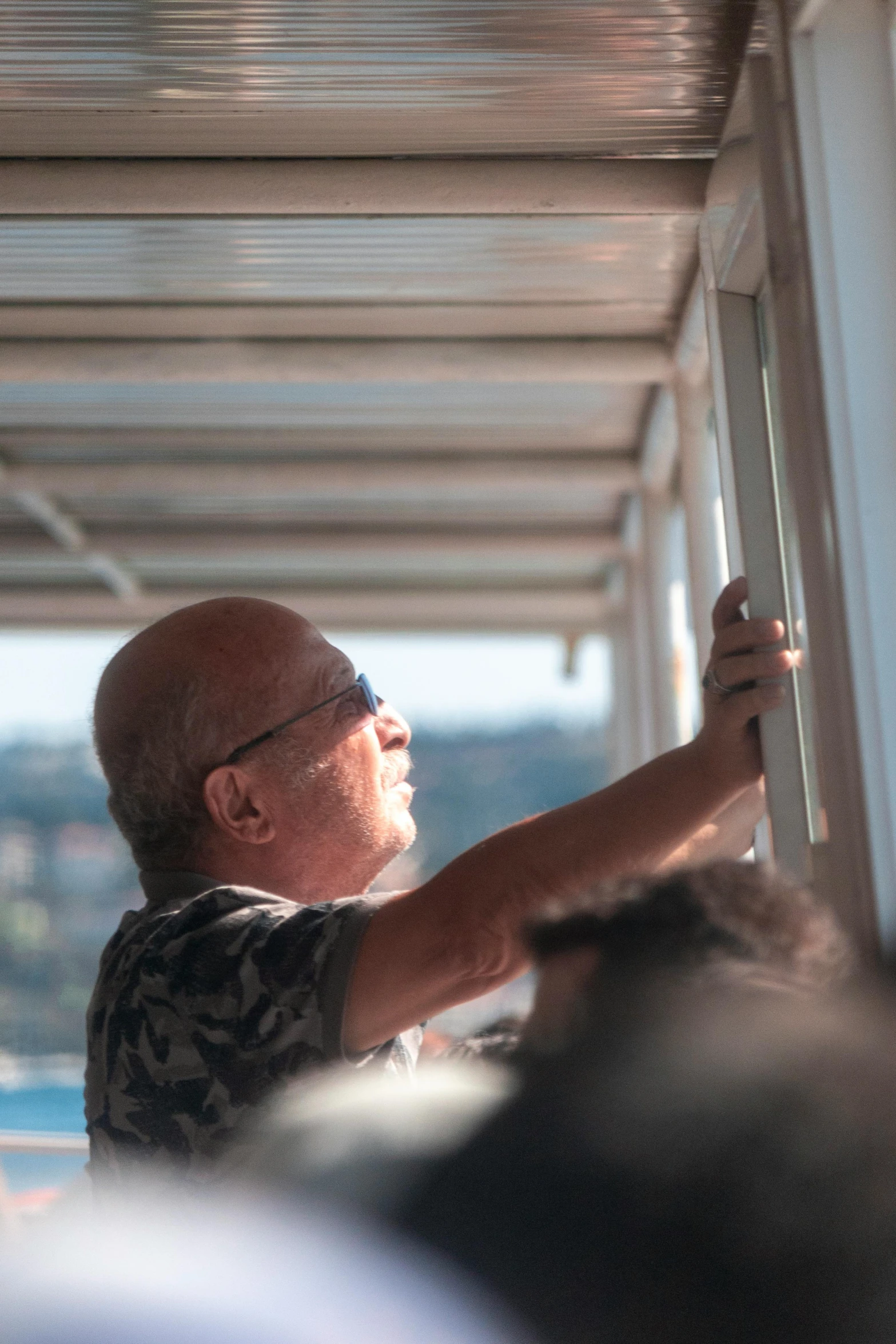 a man in a black and white shirt holding a sign in a building