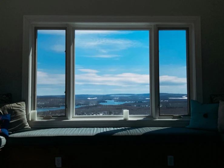a view from a window that shows the mountains in the distance