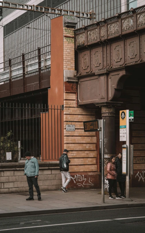 people standing outside an entrance to a building in a city