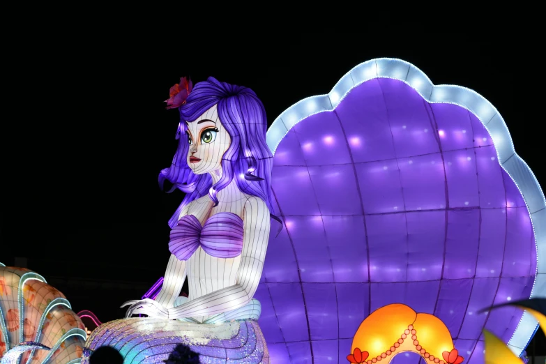 a purple woman standing in front of a big balloon
