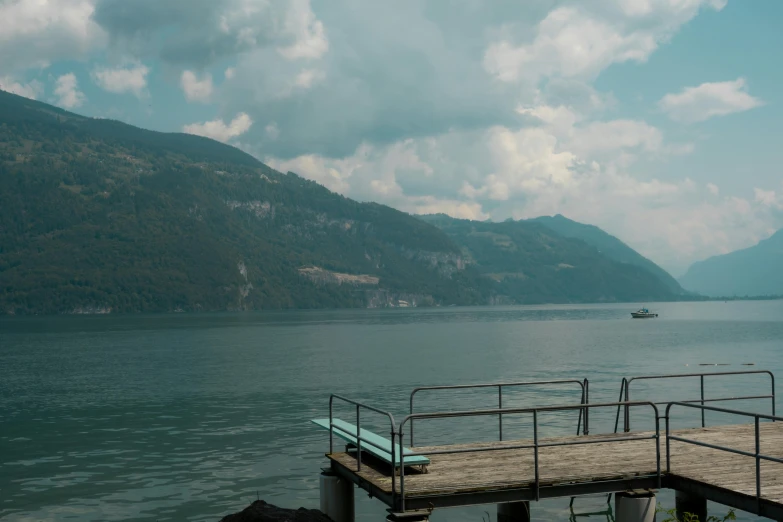 an empty dock in a lake with some boats