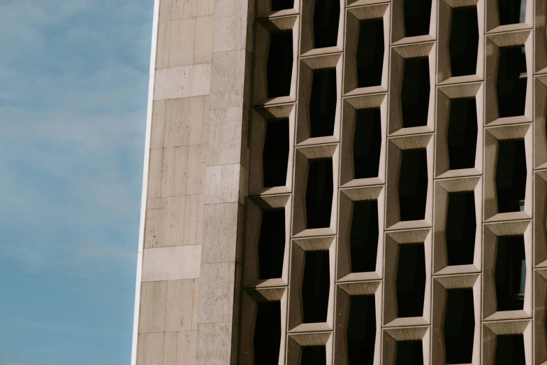 a tall, very tall brick building sitting next to a clock tower