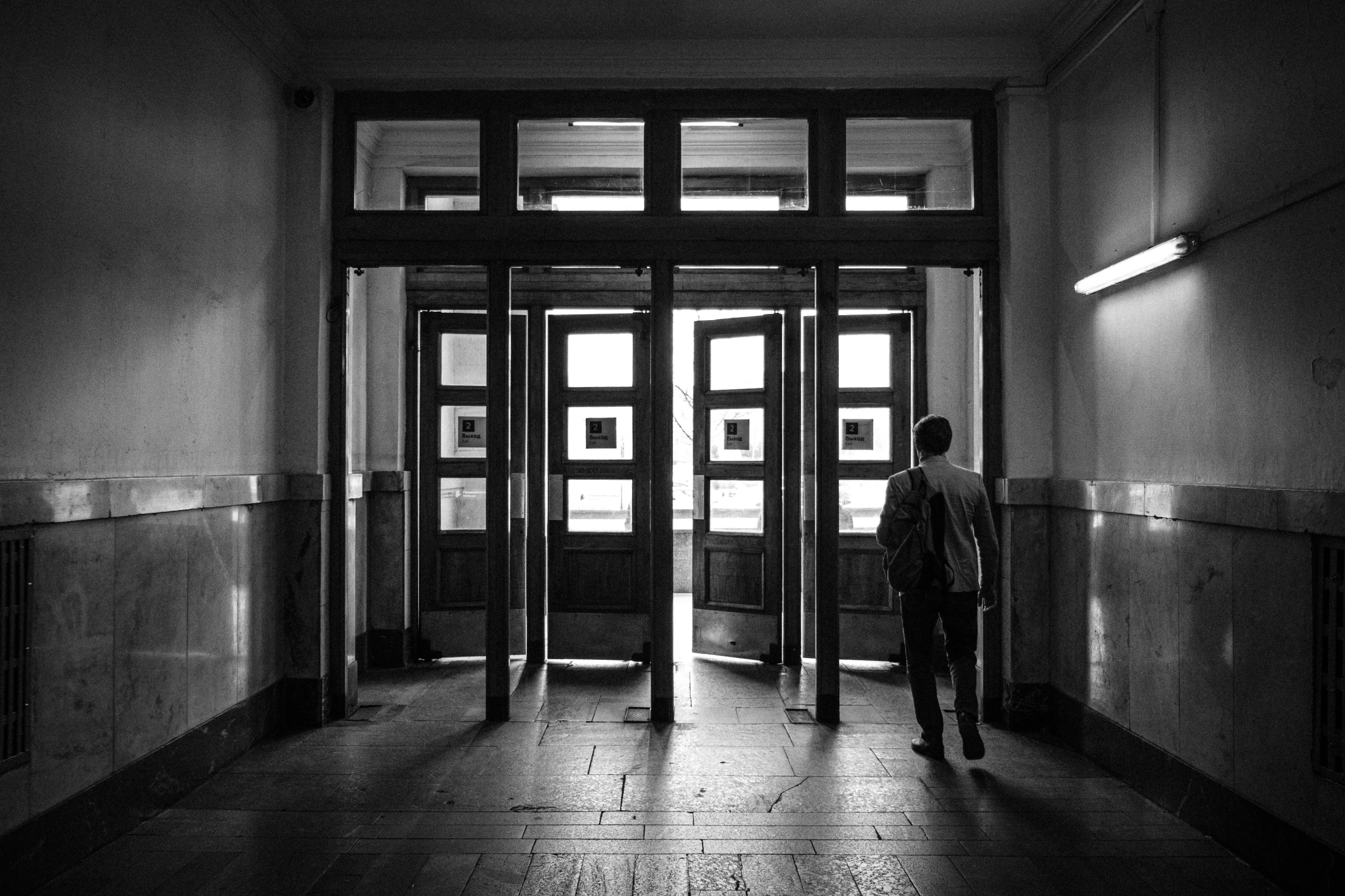 a person standing in the door way of a building