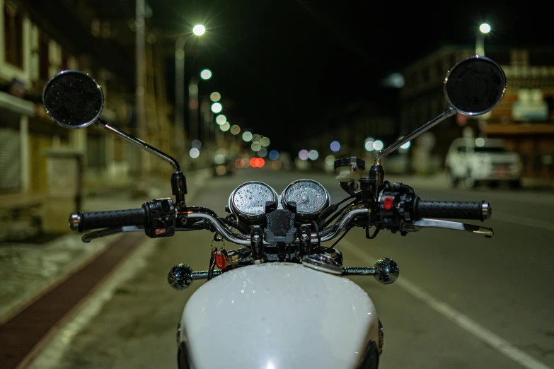 a white motorcycle sitting on the side of the street