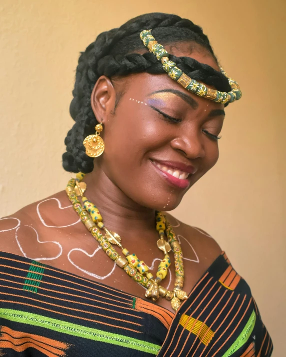 a smiling woman with two different necklaces on her head