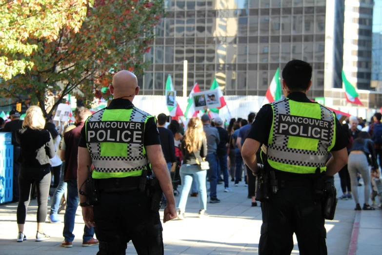 two police officers are talking in the city