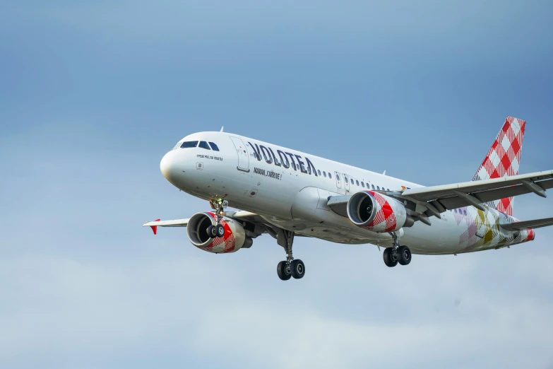 a large white airplane is flying in the sky