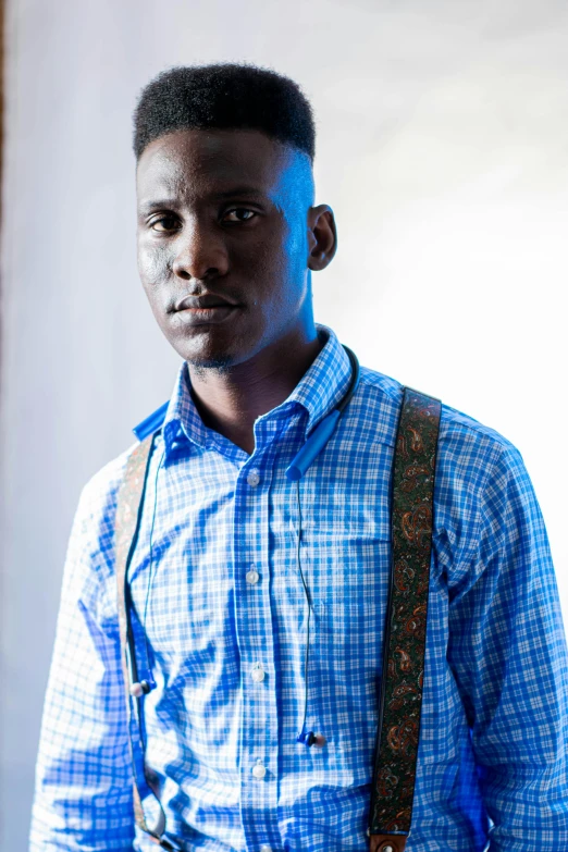 a man wearing suspenders is standing in a room