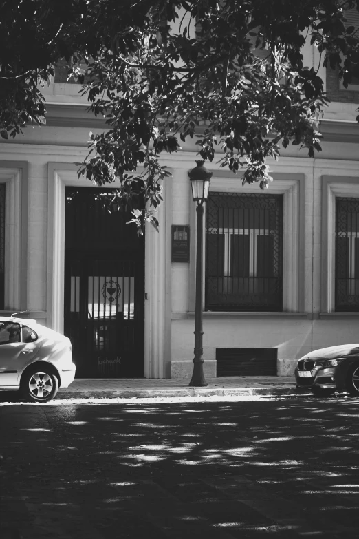 cars parked on the street in front of an empty building