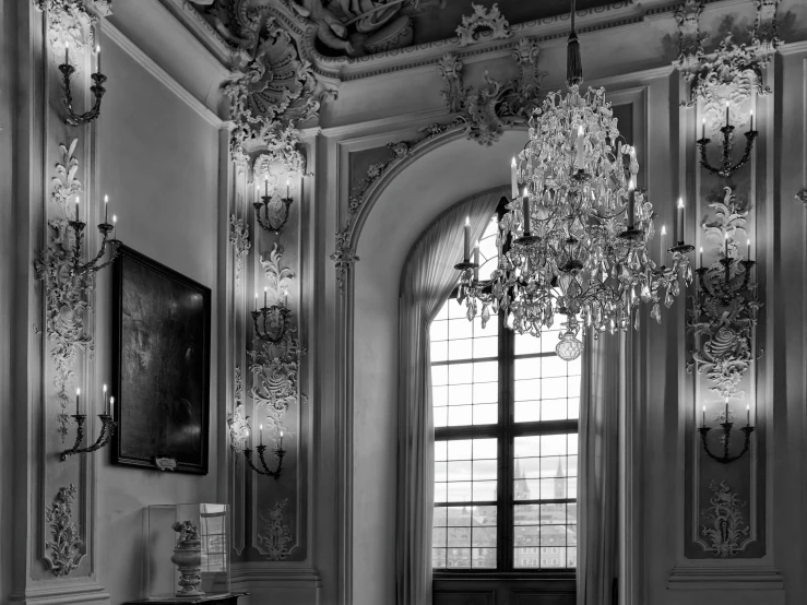 an ornate living room with chandelier and mirrors