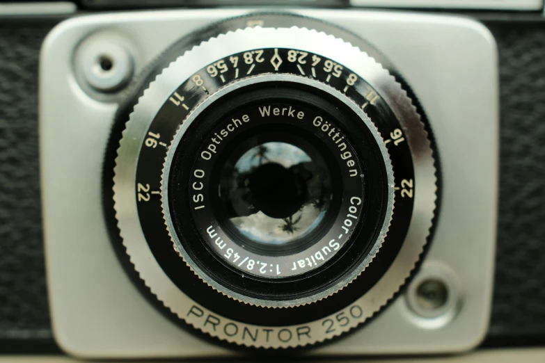 a white and black camera sitting on top of a table