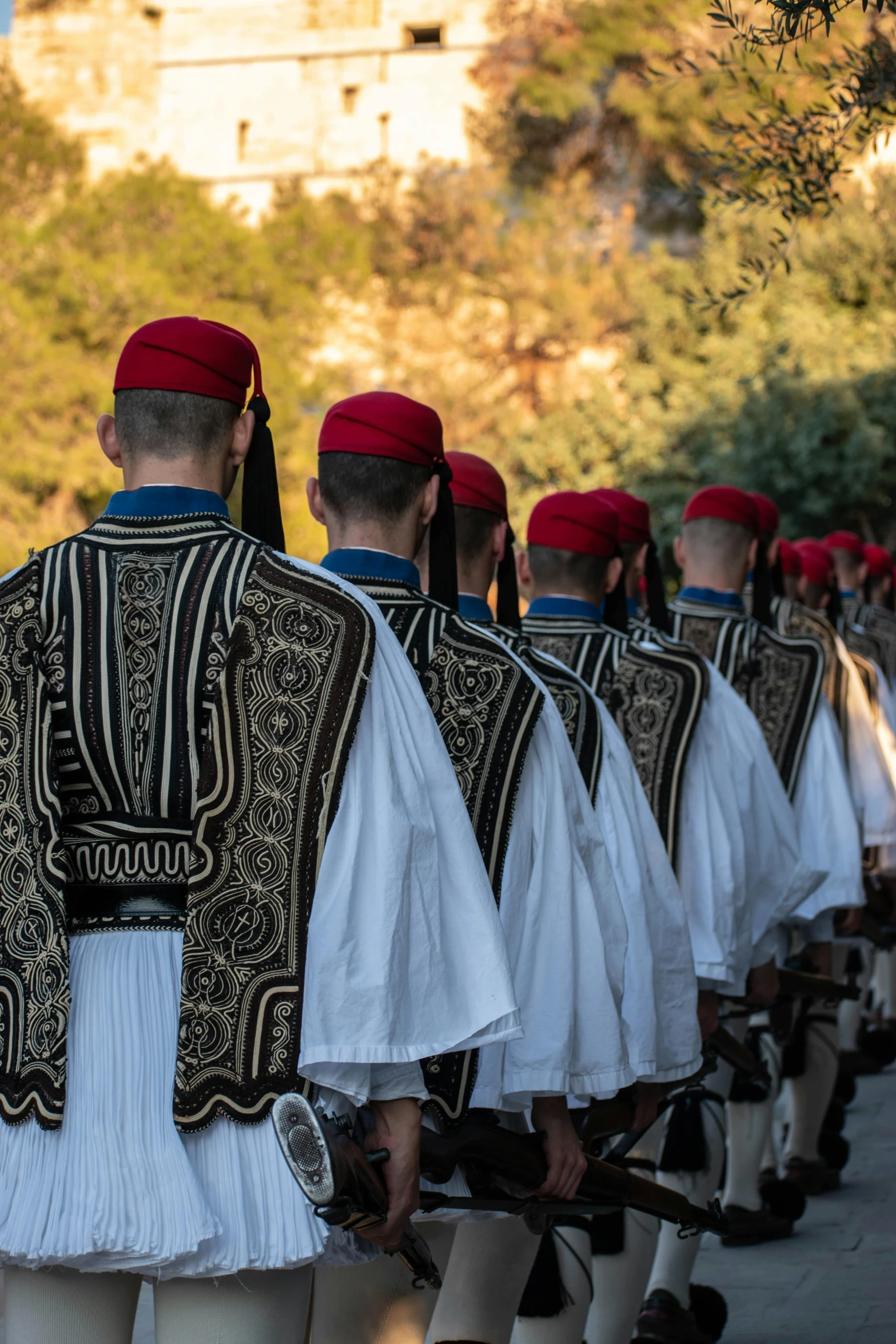 a large group of men are walking down the street