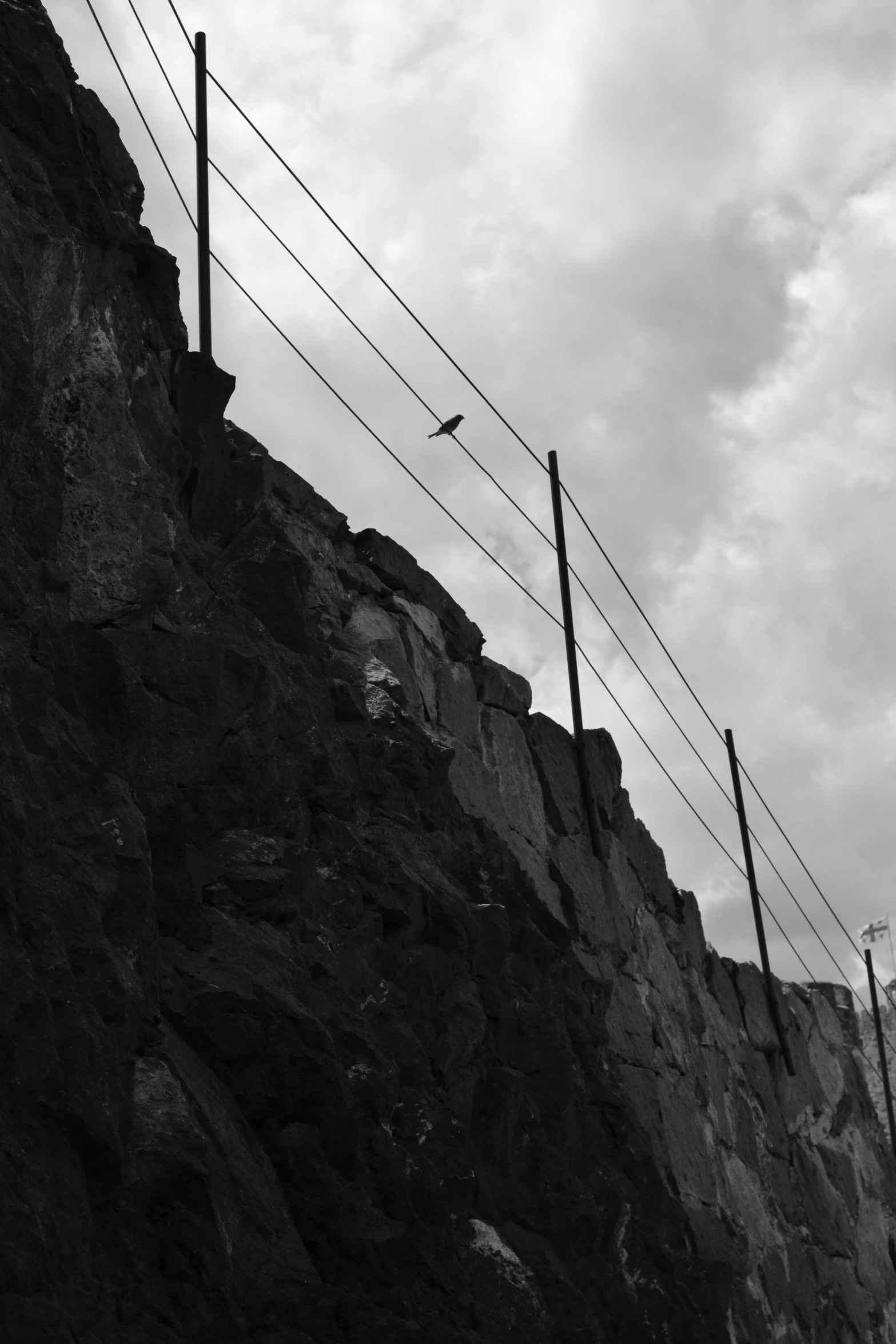 a fence sitting on top of a cliff next to a cliff