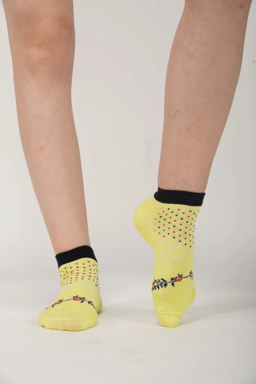 the legs and feet of a woman wearing yellow socks