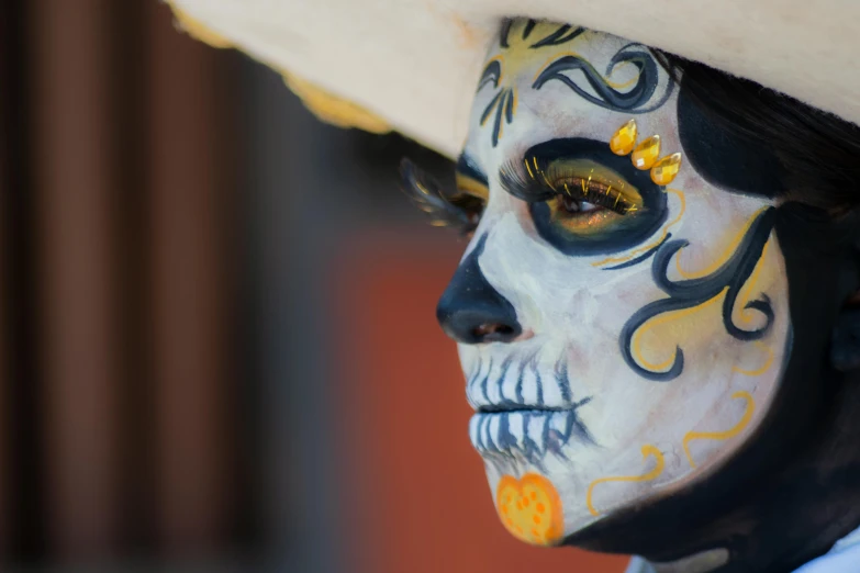 a man with white makeup and painted face looks sideways