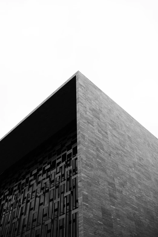 a tall building sitting under a cloudy gray sky