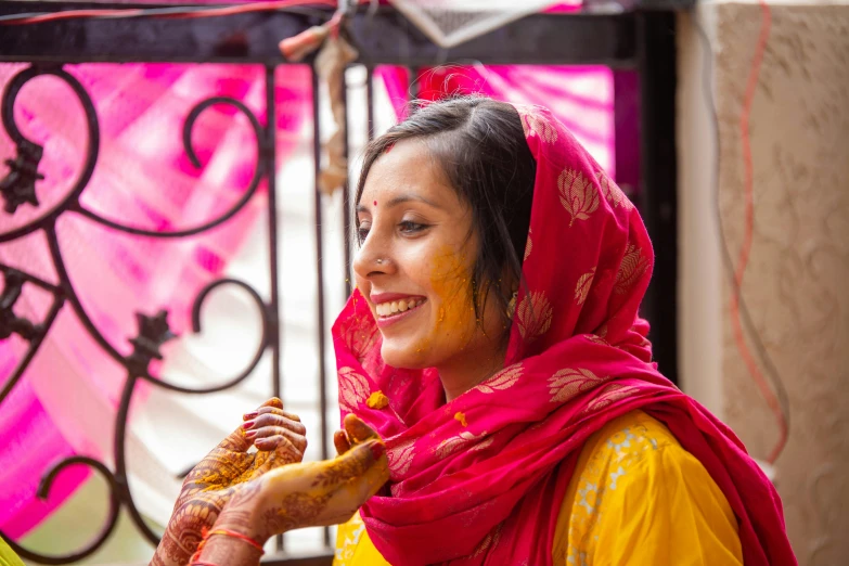 an indian woman in her traditional dress is giving food