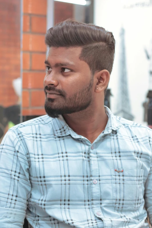 a man wearing blue shirt and a plaid shirt