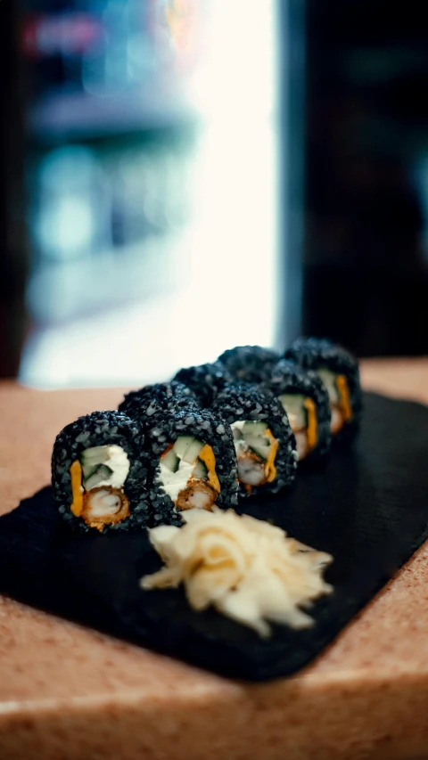 a meal made with sushi is sitting on a serving board