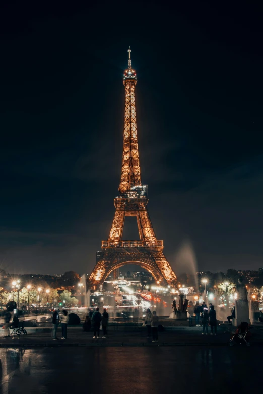 people walking around in front of the eiffel tower