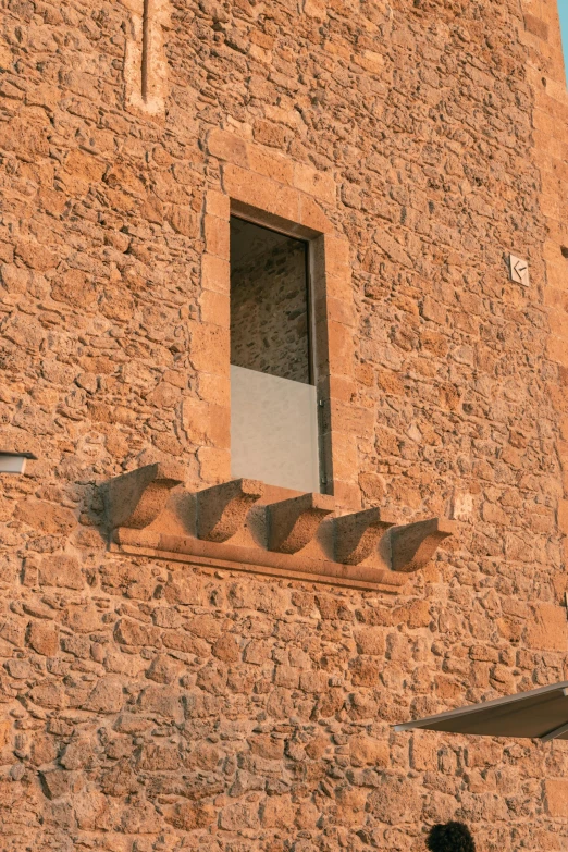 a window with two chairs and umbrellas by it