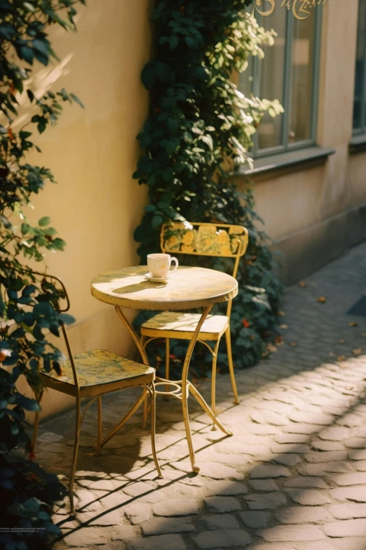 a table and chair are outside near a wall