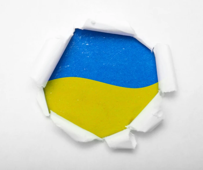 an image of torn paper with yellow and blue background