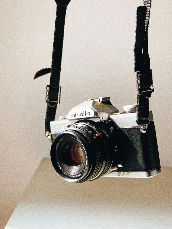 an old camera with some strap attached