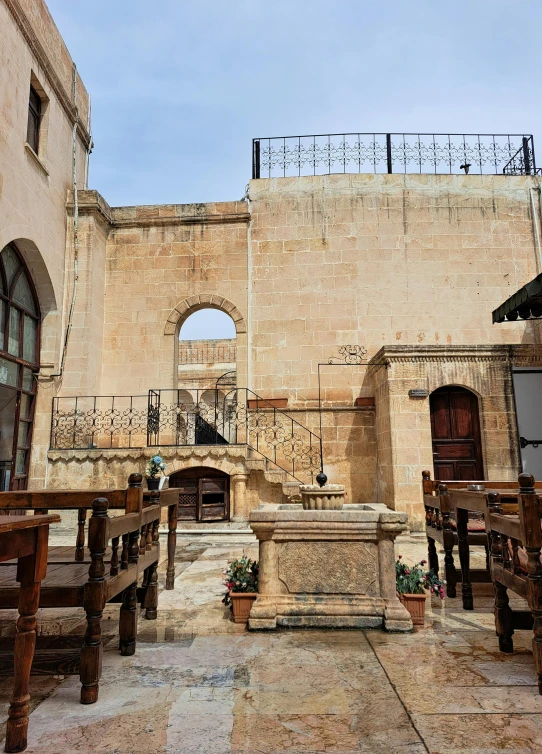 a church with an arched doorway and stone altar