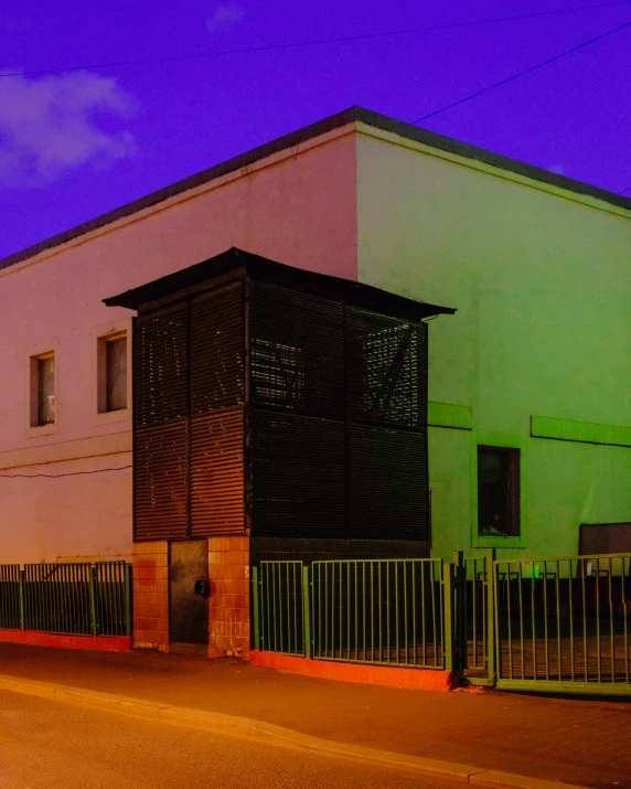 a colorful building with a fence in front of it