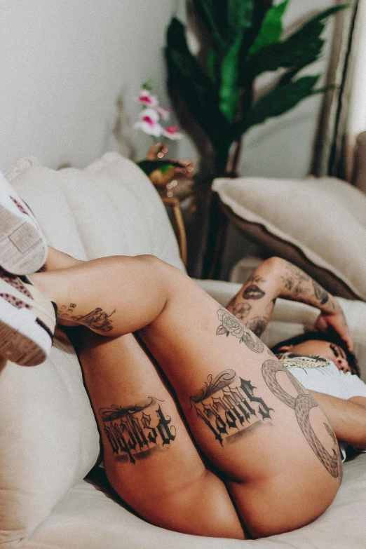 tattooed ladies in bed on the covers