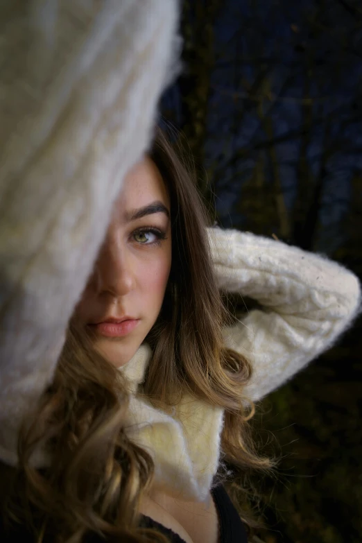 a woman is standing with her hands on her ears