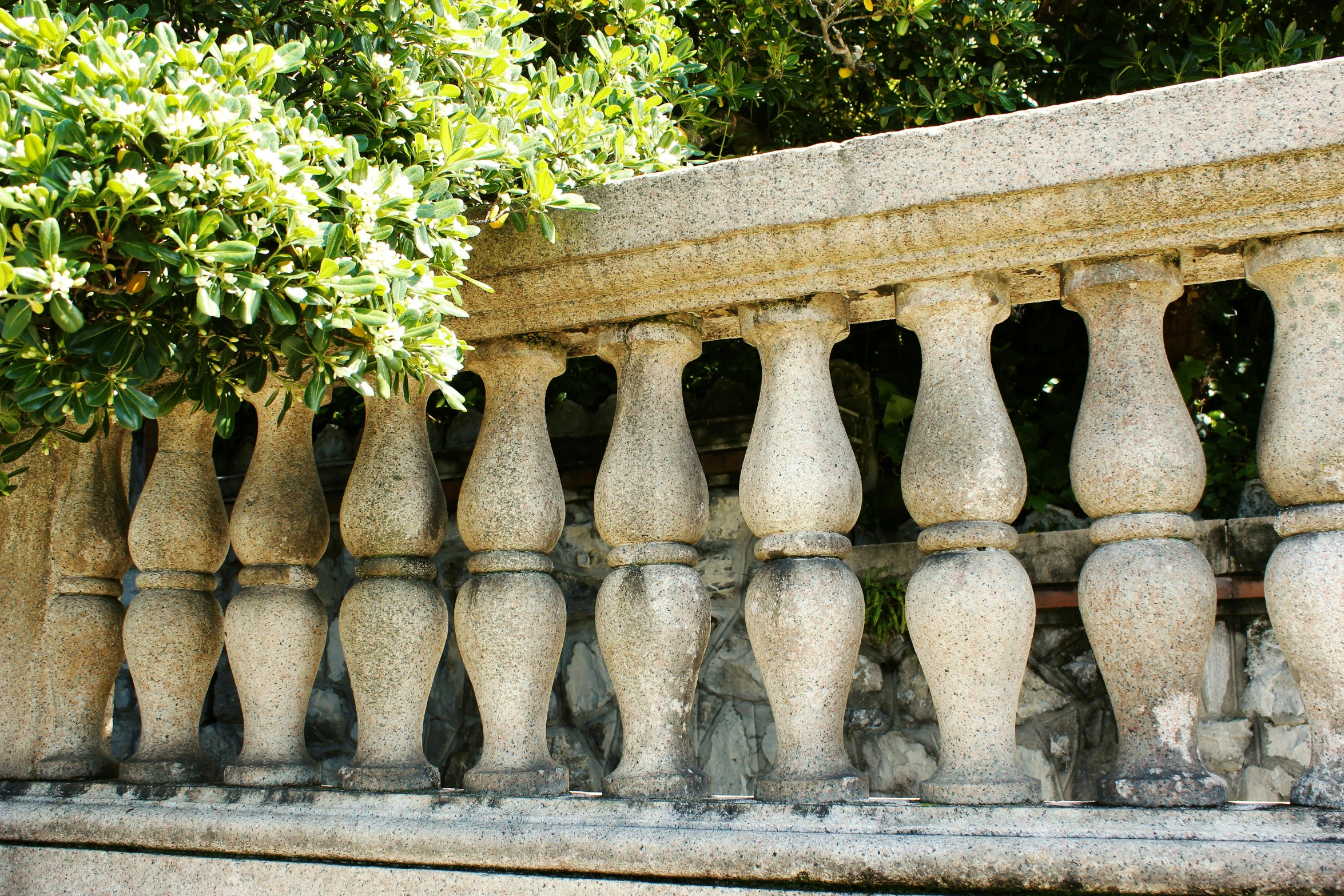 a stone wall with a group of stone planters on the top